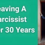 Woman in her 50s looking hopeful while standing at an open door, representing leaving a narcissist after 30 years to start a new life"