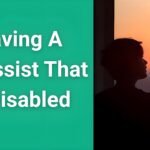 Person looking at sunrise through window, symbolizing hope and new beginnings while leaving an abusive relationship with a disabled narcissist