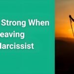 Person breaking free from chains representing staying strong when leaving a narcissist with sunrise in background symbolizing hope and new beginnings